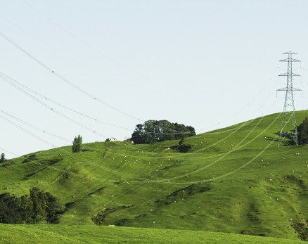 Power pylons on green hills