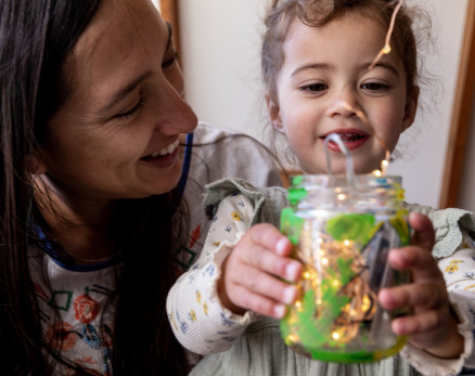 Mum and child holdiing jar of fairy lights